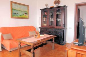 a living room with a couch and a table at Three-Bedroom Apartment in Novi Vinodolski I in Povile