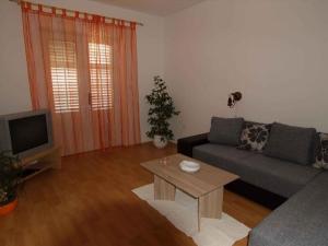 a living room with a couch and a tv at Apartment in Rab/Insel Rab 16489 in Palit
