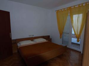 a bedroom with a bed and a large window at Apartment in Rab/Insel Rab 16489 in Palit