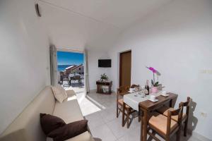 a living room with a table and a couch at Apartment Crikvenica 16 in Crikvenica