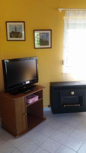 a living room with a flat screen tv on a table at Holiday home Balatonlelle - Balaton 19117 in Balatonlelle