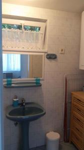 a bathroom with a sink and a window at Holiday home Balatonlelle - Balaton 19117 in Balatonlelle +24 photos