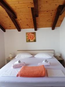a bedroom with a large bed with two towels on it at One-Bedroom Apartment in Baric Draga II in Barić Draga