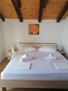 a bedroom with a large white bed with two pillows at One-Bedroom Apartment in Baric Draga II in Barić Draga