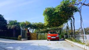 a small red car parked in a driveway at Apartment in Lopar/Insel Rab 17757 in Lopar