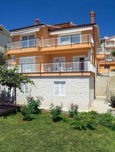 a large house with a balcony on top of it at Apartment in Rabac 16819 in Rabac