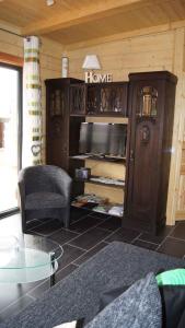 a living room with a tv and a entertainment center at Holiday home in Friedland 2712 in Kummerow