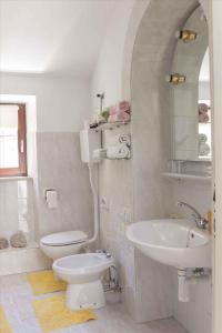 a bathroom with a toilet and a sink at Holiday home in Moscenice 15209 in Mošćenice