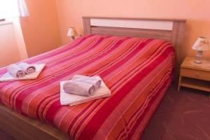 a bedroom with a bed with towels on it at Holiday home in Moscenice 15209 in Mošćenice