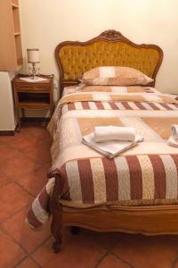 a bedroom with a bed with a blanket and a table at Holiday home in Moscenice 15209 in Mošćenice