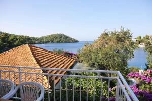 a balcony with chairs and a view of the water at Brna, otok Korcula Two-Bedroom Apartment 1 in Brna