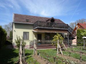 a house with a porch and a balcony at Two-Bedroom Apartment in Balatonbereny II in Balatonberény