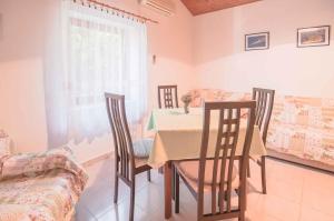 a dining room with a table and chairs at Apartments in Mali Losinj 14985B in Mali Lošinj