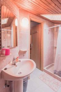 a bathroom with a sink and a bath tub at Apartments in Mali Losinj 14985C in Mali Lošinj