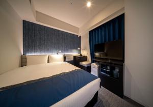 Postel nebo postele na pokoji v ubytování DEL style Ikebukuro Higashiguchi by Daiwa Roynet Hotel
