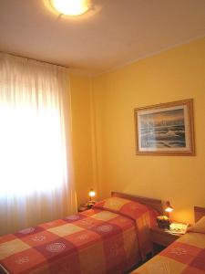 a bedroom with two twin beds and a window at Apartments in Bibione 24576 in Bibione