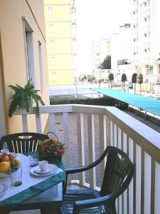 a table with a bowl of fruit on a balcony at Apartments in Bibione 24576 in Bibione