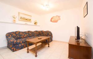 a living room with a couch and a table at Holiday home in Pomer/Istrien 9026 in Pomer