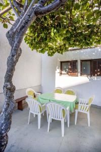 a table and chairs sitting under a tree at Apartment in Rovinj/Istrien 11479 in Štanga