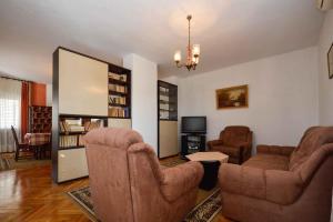 a living room with two chairs and a tv at Apartments in Premantura/Istrien 10684 in Premantura