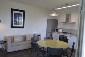 a living room with a table and a couch at Apartments in Pur/Ledrosee 22640 in Mezzolago