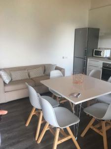 a living room with a table and chairs and a couch at Apartments in Pur/Ledrosee 22640 in Mezzolago