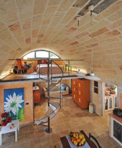 a living room with a spiral staircase in a house at Apartments in Spongano/Apulien 20947 in Spongano