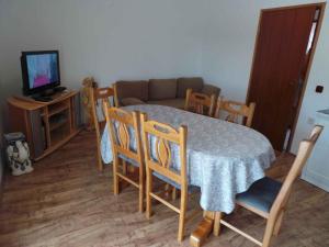 a living room with a table and chairs and a couch at Apartment in Novi Vinodolski 15375 in Novi Vinodolski