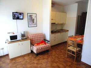 a kitchen with a chair and a table with a microwave at Apartments in Bibione 24565 in Bibione