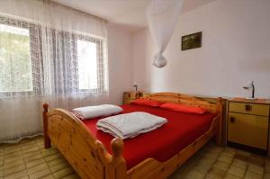 a bedroom with a wooden bed and a window at Apartment in Pula/Istrien 17325 in Vintijan