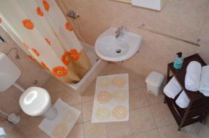 a bathroom with a sink and a toilet and a shower at Palit Apartment 1 in Palit