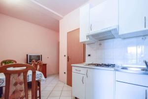 a kitchen with a sink and a stove top oven at Apartments in Pjescana Uvala/Istrien 10996 in Pješčana Uvala