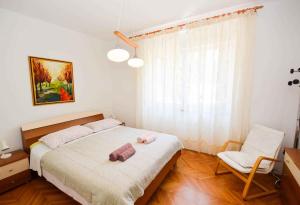 a bedroom with a bed with a stuffed animal on it at Pula Apartment 11 in Veruda