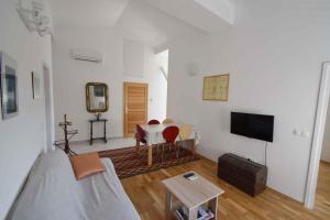 a living room with a couch and a table at Biograd na Moru Apartment 1 in Biograd na Moru