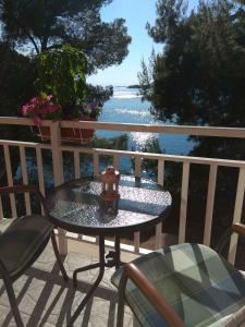 a table and chairs on a balcony with a view of the ocean at Apartment in Brna - Insel Korcula 6397 in Brna