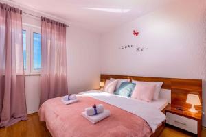a bedroom with a bed with two towels on it at Crikvenica Apartment 21 in Dramalj