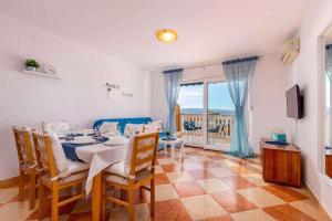 a dining room with a table and chairs and a balcony at Crikvenica Apartment 2 in Dramalj