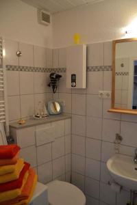 a bathroom with a sink and a toilet and a mirror at Wendtorf Apartment 2 in Wendtorf