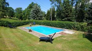 a small swimming pool in a yard with a lawn at Apartment in Dorfchemnitz bei Sayda 3110 in Wolfsgrund