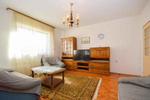 a living room with a couch and a tv at Two-Bedroom Apartment in Pula IX in Veruda