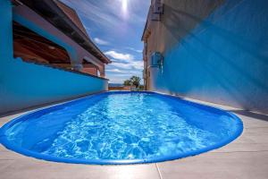 a large blue swimming pool on the side of a building at Dramalj Apartment 3 in Dramalj