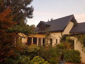 a white house with a black roof at Holiday home in Coswig 3105 in Möllensdorf