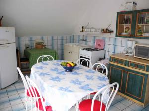 a kitchen with a table with a bowl of fruit on it at Apartment in Fonyod - Balaton 33083 in Fonyód