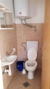 Apartment Lopar 4 في لوبار: حمام مع مرحاض ومغسلة