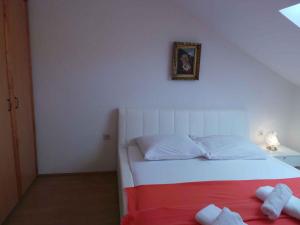 a bedroom with a bed with two towels on it at Apartment Crikvenica, Vinodol 8 in Crikvenica
