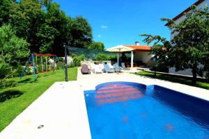 a swimming pool in the backyard of a house at House and Apartments in Labin 8758 in Labin