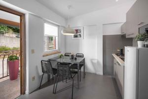 a kitchen with a table and chairs and a refrigerator at Apartment Rabac 23 in Rabac