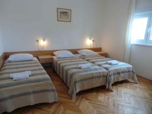 a room with two beds in a room at Apartment Ljubac 21 in Ljubač