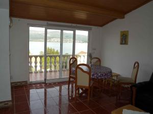 a dining room with a table and chairs and a balcony at Apartment in Pridraga/Zadar Riviera 7998 in Gospić