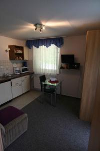 ein Wohnzimmer mit einem Tisch und einer Küche in der Unterkunft Apartment Todtmoos 2 in Todtmoos